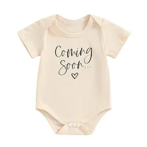 Apricot baby bodysuit with 'Coming Soon' text for pregnancy announcement