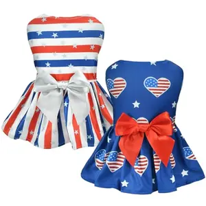 Two small dogs wearing Vehomy patriotic dresses - one with stars and stripes, the other with heart-shaped flags