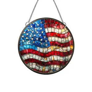 Round acrylic suncatcher with American flag design hanging from a suction cup