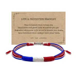 Red white blue string wrap bracelet with American flag colors on a wrist