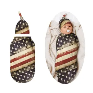 Flag swaddle wrap and matching hat on a sleeping newborn