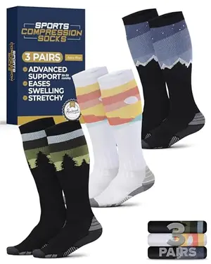 Pembrook compression socks with mountain, sunset, and tree designs laid flat