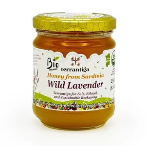 Wild Lavender Organic Raw Honey from Sardinia in a glass jar with a wooden dipper