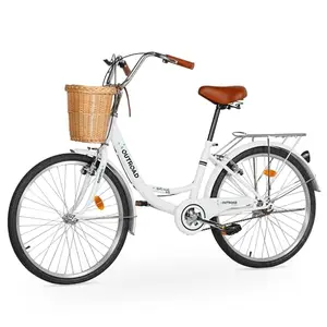 White MarKnig cruiser bike with basket and rear rack on a beach path