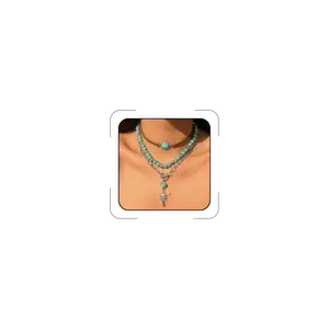 Layered necklace with turquoise beads and western charms on a flat lay