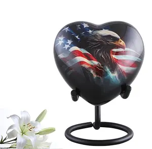 Heart-shaped keepsake urn with eagle and flag, includes display stand