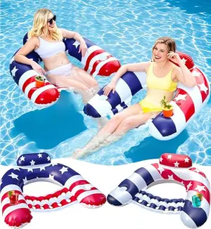 Two American flag pool lounge chairs floating in pool