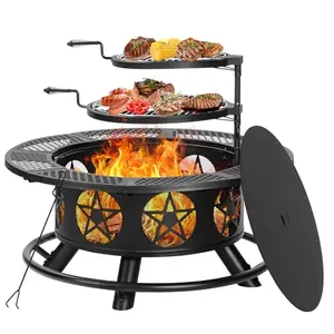 Large round black fire pit with dual grills and decorative cutouts on a patio