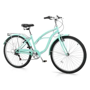 Green CamPingSurvivals cruiser bike with front basket on a coastal trail