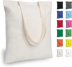 Three plain beige cotton tote bags displayed on a table