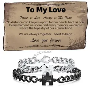 Silver and black puzzle heart interlocking couple bracelets on a velvet background