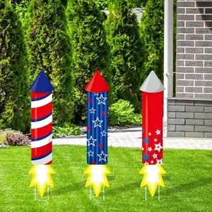 Three red white and blue plastic yard signs with firework designs and textual messages