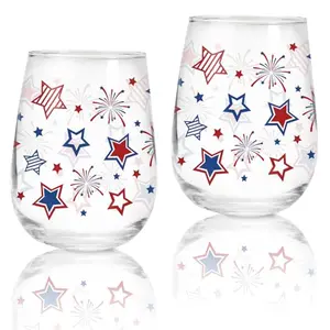 Two stemless wine glasses with red, blue, and star firework design