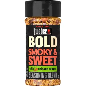 Weber BOLD Smokey & Sweet seasoning bottle with grilled steak and vegetables