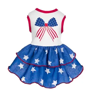 Fluffy small dog in Fitwarm royal blue ruffle dress with bow print and star-themed skirt