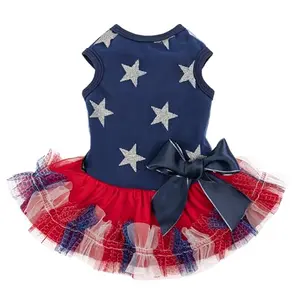 Small dog looking glamorous in Fitwarm navy blue dress with silver star tulle skirt and oversized bow