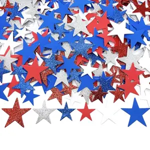 Red, white, and blue glitter foam star stickers arranged on a wooden table
