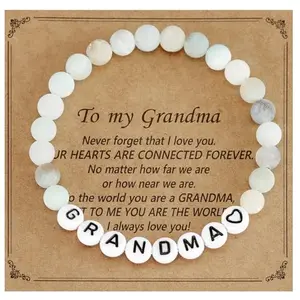 Stretch bracelet with polished steel beads and a central round charm engraved with a message for grandma