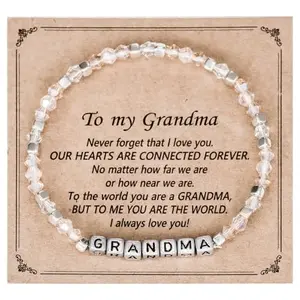 Stretch bracelet with individual metal letter beads spelling 'GRANDMA' with a small charm attached