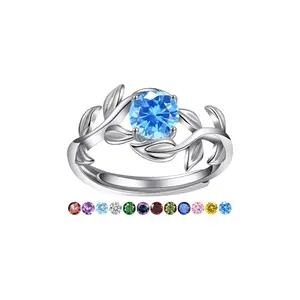 Yaresul white gold adjustable ring with blue topaz and leaf branch design