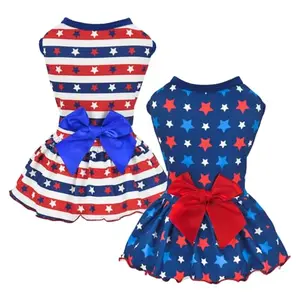 Pair of small dogs wearing Vehomy USA flag dresses with star and stripe motifs, ready for Independence Day