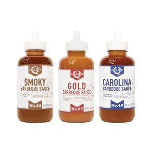 Lillie's Q three-bottle combo pack on a grill table with smoked meats