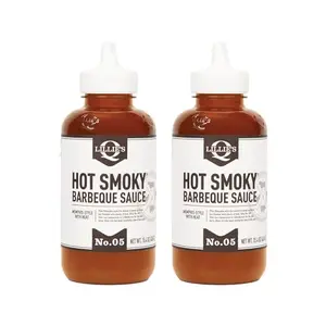 Lillie's Q Hot Smoky BBQ Sauce 2-pack with grilled ribs and smoke