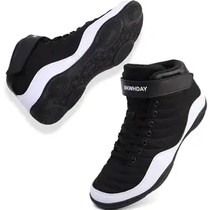 BKWHDAY kids wrestling shoes in black and white with mesh upper on a wrestling mat