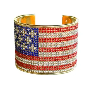 Gold-plated cuff bracelet with red, white, and blue crystals in an American flag pattern on a wrist