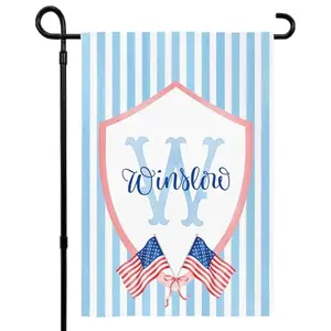 Personalized patriotic stripes garden flag with a monogram initial and photo upload option displayed in a garden setting