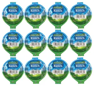Hidden Valley Original Ranch dipping cups on a picnic table with wings