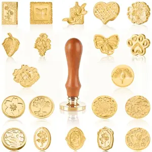Generic wax seal stamp kit with 21 stamp heads and wooden handle on a letter