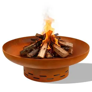 Rust-colored round steel fire pit with open bowl design on a patio