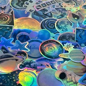 YOKSAS holographic blue space stickers pack with planets, stars, and astronauts on a table