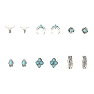 Six pairs of earrings with western motifs like boots, crosses, and turquoise on a card