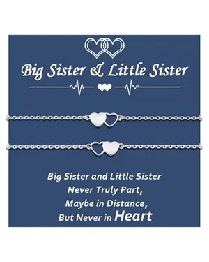 Two matching heart bracelets for sisters with a heart clasp design on a card