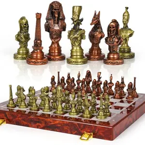Large Egyptian metal chess set with gold and bronze pieces on marble-style folding board