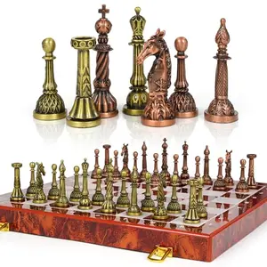 Vintage metal chess set with bronze-toned pieces on folding marble-design board