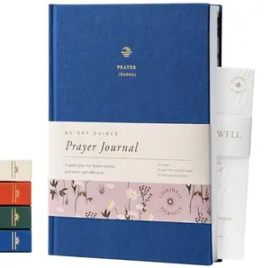 Lightwell 90-day guided prayer journal navy blue cover open showing daily prompts