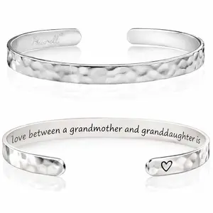 Silvertone cuff bracelet with engraved 'The love between a grandmother and granddaughter is forever' on a polished inner side