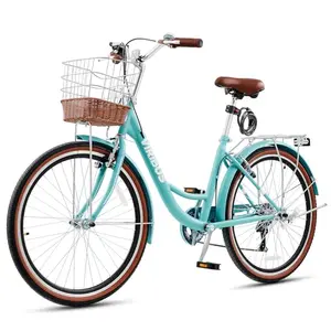 Vintage turquoise VIRIBUS cruiser bike with rattan basket on a sunny beach path