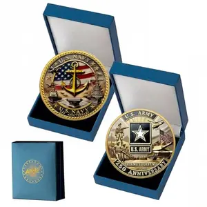 Set of two gold-plated Army and Navy challenge coins on a white surface