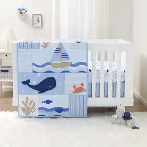 Blue and white nautical themed crib bedding set with anchors and sailboats