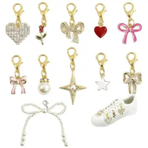 Cohortstar gold tone shoe lace charms on sneakers