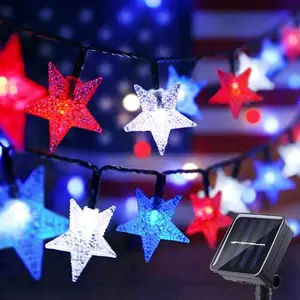 Serpouliom solar star string lights draped on a patio bush at dusk