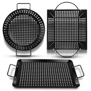 Three black non-stick grill baskets in different shapes on a wooden table