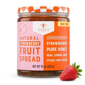 Nate's Honey strawberry fruit spread jar next to a honey dipper