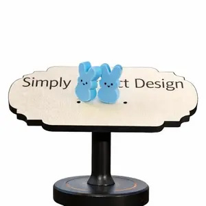 Pair of blue bunny stud earrings with hand-painted faces on white background