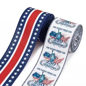 Two rolls of burlap ribbon with stars, stripes, and Statue of Liberty design