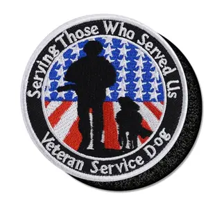 Round patch with silhouette of human and dog and text Serving Those Who Served